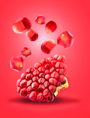 Cut the pomegranate   isolated on red background. Levitation.
