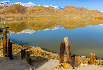 Reflections of The Foothills and Pier With The Sierra Nevada Mountain Range on Diaz Lake, Lone...