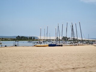 White sand beach at Cap Ferret, France with view of boats and Dune du Pyla during summer