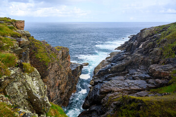 Rocky Cliff Overlooking Body of Water