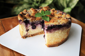 large piece of delicious blueberry cheesecake placed on the garden table