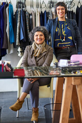 Smile, women and portrait of business owners in store for clothing sale, discount or deal for teamwork. Happy, mentor and stylish female fashion designer with internship in retail shop or boutique.
