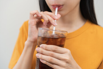 Smile happy thirsty asian young woman drinking or sip, holding glass of ice sparkling soda, cola...