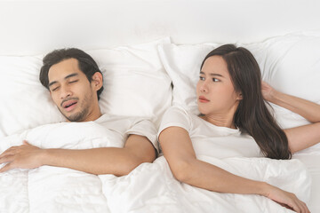 Snoring couple health concept, asian man snore and sleeping at home while woman, wife insomnia...