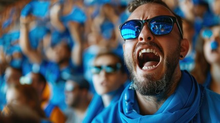 Blue sports fans scream as they support their team from the field.