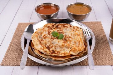 Roti Parata or Roti canai dhal and curry sauce, its a popular Malaysian breakfast
