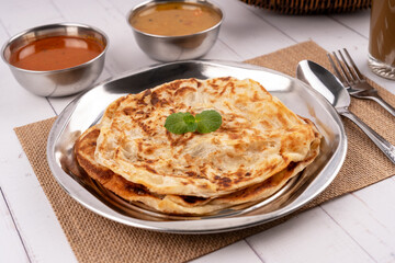 Close up of Roti canai, dhal and curry sauce Malaysian food
