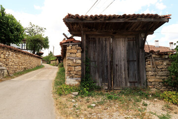 Big wooden gate, door in an old stone wall in the traditional village of Arbanasi, close to Veliko Tarnovo, Bulgaria