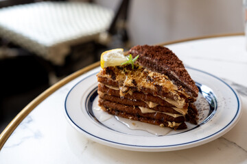 Medovik, Russian and Soviet honey cake served on plate in the cafe