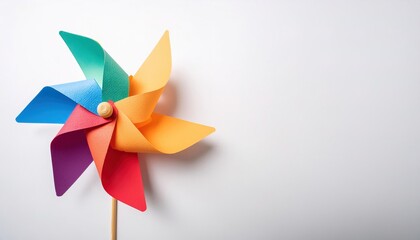 pinwheel or windmill paper origami isolated on white background simple starter craft for kids for weekend entertainment. ESG and Clean Energy Concept. Wind Turbine Paper into the Sky. Decrease Carbon
