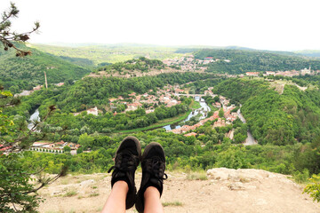 Sitting on the love swing on Garga Bair, black shoes in front of a scenic view over the city of...