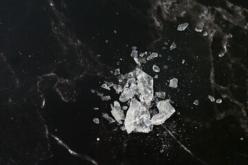 Lumps of alum on a black background. It is a mineral with clear, white crystals, odorless,...