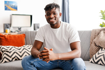Portrait of smiling handsome African American young man wearing stylish casual white t shirt