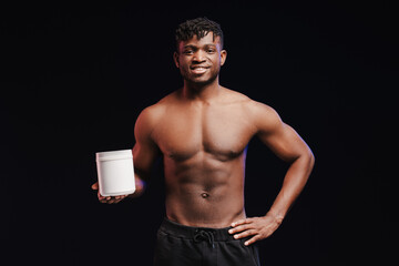 Smiling, african american man, pumped athlete with bare torso, holding white bottle, mockup