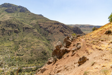 The Solitary Trek: A Lone Hiker Descends a Rocky Mountain Trail