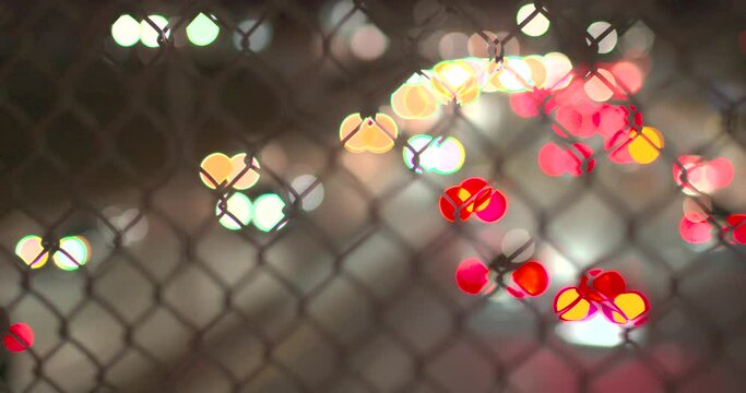 Traffic bokeh in Queens NYC through fence for slow motion