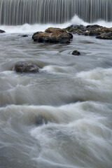 Water flowing between the rocks, beautiful water panorama, waterfall