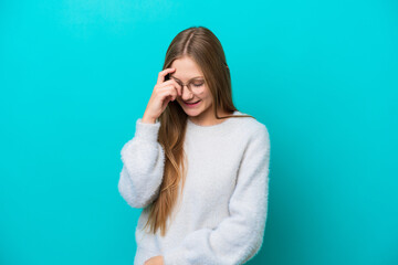 Young Russian woman isolated on blue background laughing