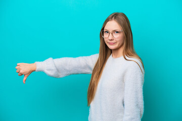 Young Russian woman isolated on blue background showing thumb down with negative expression