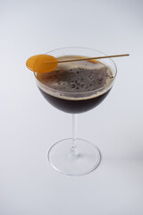 Closeup on alcoholic martini espresso cocktail in glass on white background
