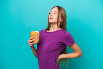 Young Russian woman catching french fries isolated on blue background suffering from backache for...