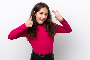 Little girl isolated on white background showing ok sign and thumb up gesture