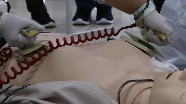 Medical Team Using Defibrillator During CPR Emergency Resuscitation