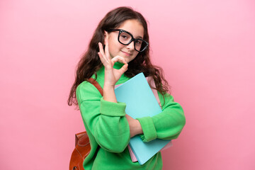 Little student girl isolated on pink background showing ok sign with fingers