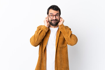 Caucasian handsome man with beard wearing a corduroy jacket over isolated white background...