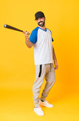 Full-length shot of a man playing baseball over isolated yellow background