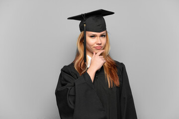Young university graduate girl over isolated background thinking