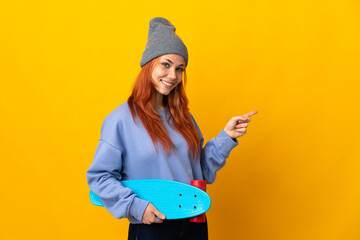 Teenager Russian skater girl isolated on yellow background pointing finger to the side