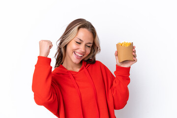 Young Russian girl holding fried chips isolated on white background celebrating a victory
