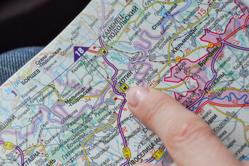 Naklejka premium A map and a hand pointing to the town of Khotyn in the Chernivtsi region, Ukraine