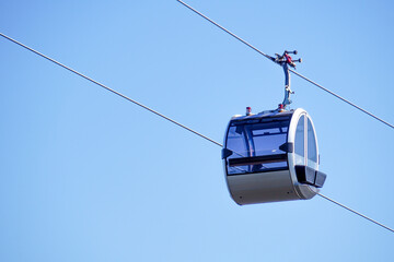 Empty cable car cabin against the sky. Modern glass lift cabin.