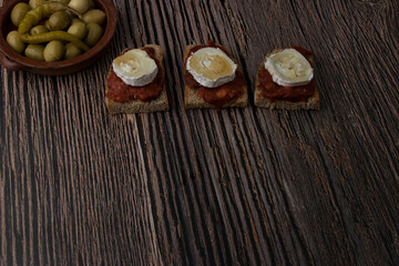 Three slices of toasted bread with sobrasada, goat's cheese and honey.