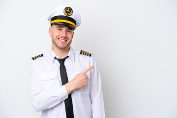 Airplane caucasian pilot isolated on white background pointing to the side to present a product © luismolinero