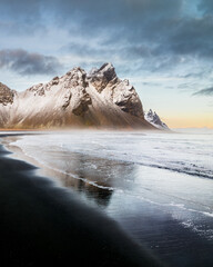 Snow-covered Vestrahorn mountain and icy landscape at Stokksnes beach, South East Iceland