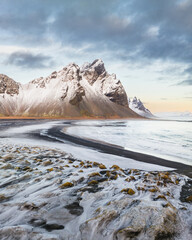 Snow-covered Vestrahorn mountain and icy landscape at Stokksnes beach, South East Iceland