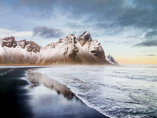 Snow-covered Vestrahorn mountain and icy landscape at Stokksnes beach, South East Iceland