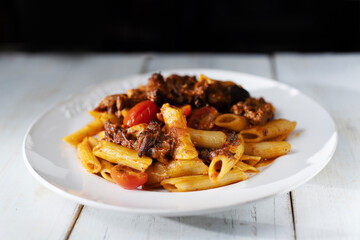 italian penne pasta in oxtail bolognese sauce