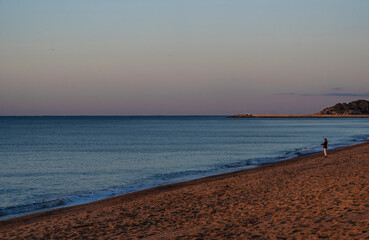 Sunrise with the first hours of the morning sun illuminating apartments and the Aro beach of the Mediterranean Sea.