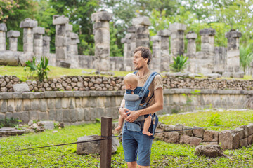 Fototapeta premium Father and son tourists observing the old pyramid and temple of the castle of the Mayan architecture known as Chichen Itza these are the ruins of this ancient pre-columbian civilization and part of