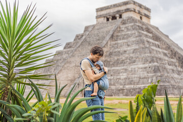 Father and son tourists observing the old pyramid and temple of the castle of the Mayan...