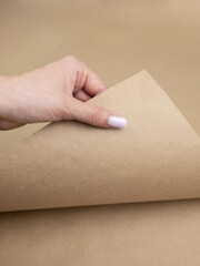 A woman's hand holds a crafting paper