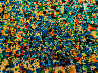 A surface of colorful mosaic tiles in close-up with many different colors.