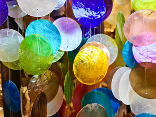Close-up of a colorful glass wind chime with many colors.