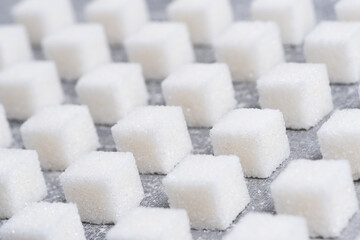 Refined sugar cubes are laid out in clear geometric lines.