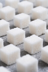 Refined sugar cubes are laid out in clear geometric lines.