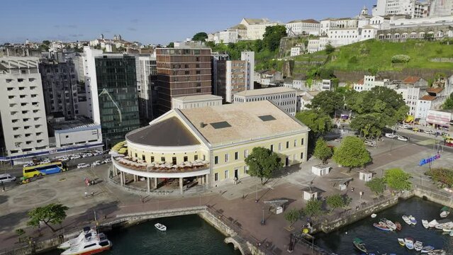 Drone orbits to the right in medium shot around Mercado Modelo in Salvador, Bahia, Brazil